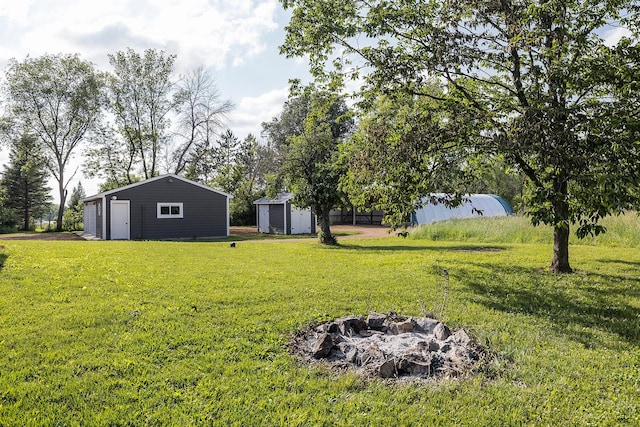 3546 230th St E, Prior Lake, MN 55372 - view of grassy yard with an outdoor structure and a detached garage