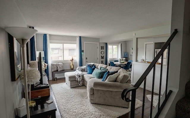 6303 84th Ct N, Brooklyn Park, MN 55445 - living area with a textured ceiling, wood finished floors, and stairs