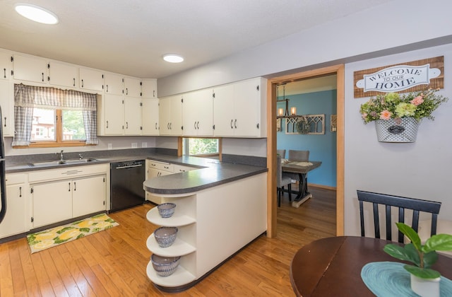 471 Tyrol Dr, Brainerd, MN 56401 - kitchen with dishwasher, dark countertops, a sink, open shelves, and light wood-type flooring