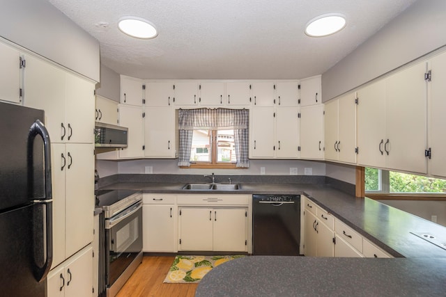 471 Tyrol Dr, Brainerd, MN 56401 - kitchen featuring black appliances, dark countertops, a sink, and plenty of natural light