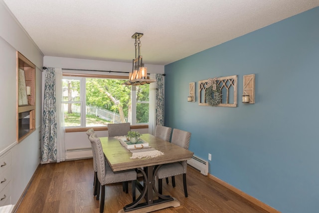 471 Tyrol Dr, Brainerd, MN 56401 - dining space with a baseboard heating unit, a baseboard radiator, dark wood-style flooring, and a textured ceiling