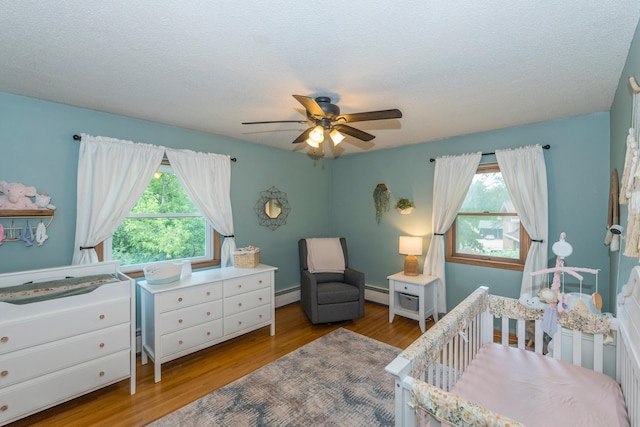 471 Tyrol Dr, Brainerd, MN 56401 - bedroom with a baseboard radiator, multiple windows, and wood finished floors