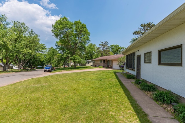 471 Tyrol Dr, Brainerd, MN 56401 - view of green lawn with concrete driveway and an attached garage