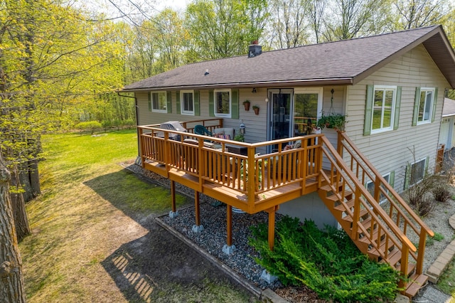 33240 Gary Dr, Grand Rapids, MN 55744 - rear view of house with a deck, a yard, a chimney, and roof with shingles