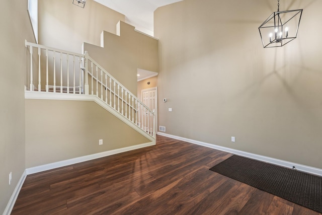 1741 Prescott Ln, Chaska, MN 55318 - stairs featuring wood finished floors, baseboards, a chandelier, and a towering ceiling