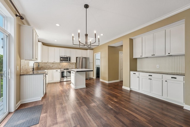 1741 Prescott Ln, Chaska, MN 55318 - kitchen featuring appliances with stainless steel finishes, tasteful backsplash, a chandelier, dark wood-style flooring, and crown molding
