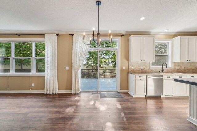 1741 Prescott Ln, Chaska, MN 55318 - kitchen featuring stainless steel dishwasher, a sink, a chandelier, decorative backsplash, and white cabinetry