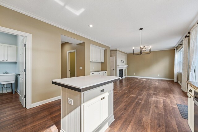 1741 Prescott Ln, Chaska, MN 55318 - kitchen featuring dark wood-type flooring, baseboards, a kitchen island, a chandelier, and ornamental molding