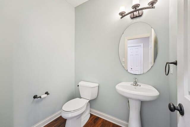 1741 Prescott Ln, Chaska, MN 55318 - bathroom featuring baseboards, toilet, wood finished floors, and a sink