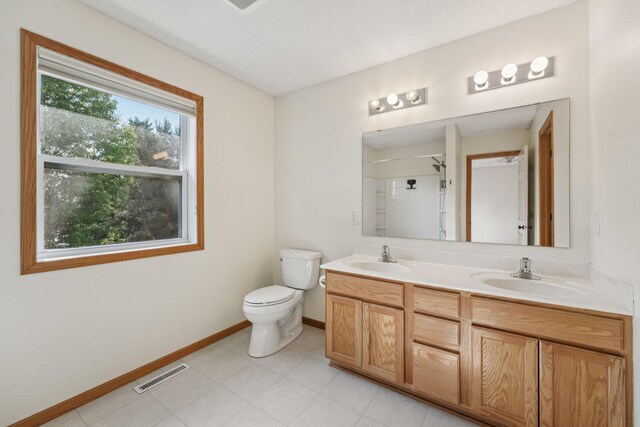 1741 Prescott Ln, Chaska, MN 55318 - full bathroom featuring baseboards, double vanity, toilet, and a shower