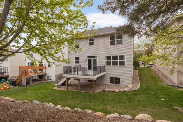 1741 Prescott Ln, Chaska, MN 55318 - back of property with stairway, a wooden deck, and a yard