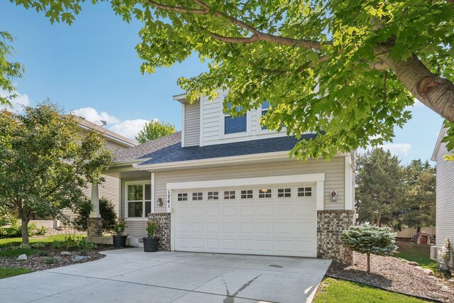 1741 Prescott Ln, Chaska, MN 55318 - view of front of house featuring driveway, a garage, and roof with shingles