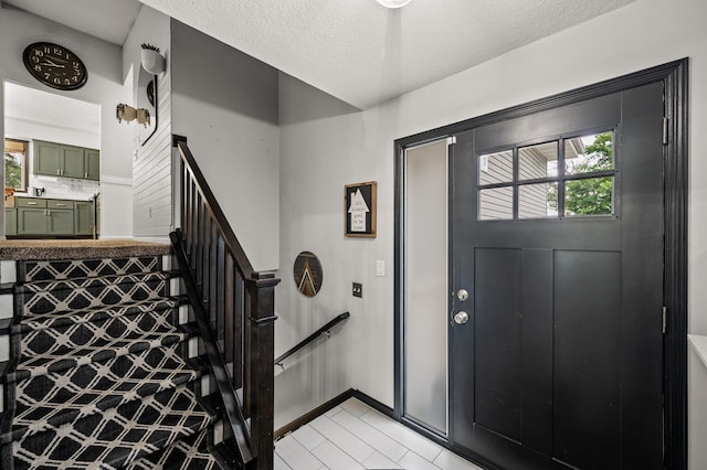 3717 80th Ave N, Brooklyn Park, MN 55443 - entrance foyer with stairway, light tile patterned floors, a textured ceiling, and baseboards