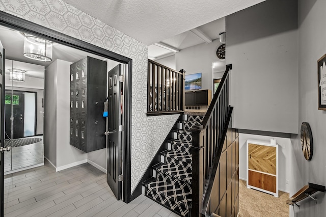 3717 80th Ave N, Brooklyn Park, MN 55443 - stairs featuring baseboards, a textured ceiling, and wood finished floors