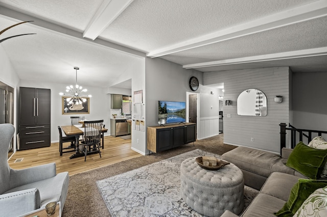 3717 80th Ave N, Brooklyn Park, MN 55443 - living room with a chandelier, light wood-style floors, baseboards, and a textured ceiling