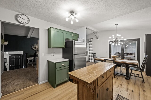 3717 80th Ave N, Brooklyn Park, MN 55443 - kitchen featuring green cabinetry, freestanding refrigerator, a chandelier, light wood-type flooring, and a textured ceiling