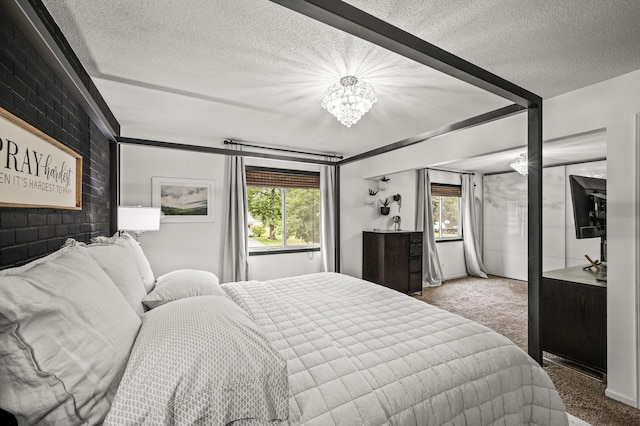3717 80th Ave N, Brooklyn Park, MN 55443 - bedroom with a chandelier, carpet, and a textured ceiling