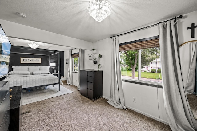 3717 80th Ave N, Brooklyn Park, MN 55443 - bedroom with a chandelier, carpet flooring, a textured ceiling, and baseboards