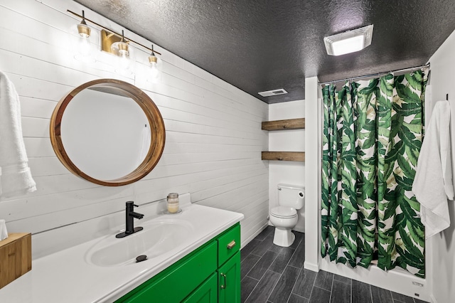 3717 80th Ave N, Brooklyn Park, MN 55443 - full bathroom with wooden walls, vanity, wood tiled floors, toilet, and a textured ceiling