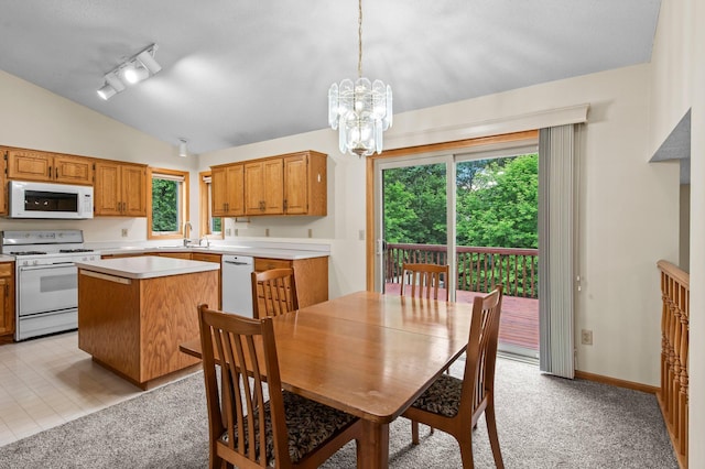 13842 Redwood St NW, Andover, MN 55304 - dining area featuring lofted ceiling, a chandelier, healthy amount of natural light, and light carpet