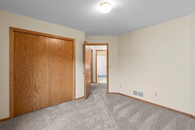 13842 Redwood St NW, Andover, MN 55304 - unfurnished bedroom with light carpet, a closet, a textured ceiling, and baseboards