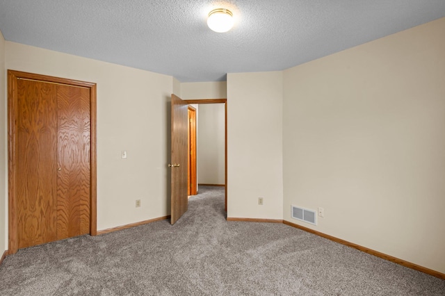 13842 Redwood St NW, Andover, MN 55304 - unfurnished bedroom with carpet flooring, a textured ceiling, and baseboards