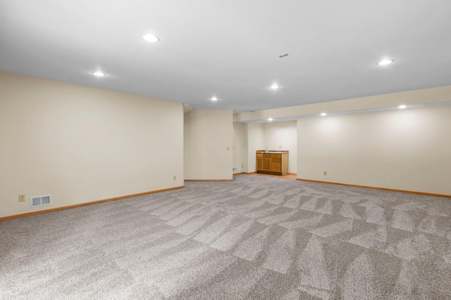 13842 Redwood St NW, Andover, MN 55304 - finished below grade area with baseboards, light carpet, and recessed lighting