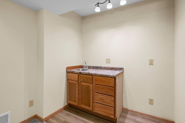 13842 Redwood St NW, Andover, MN 55304 - bar area featuring a sink and light wood-type flooring