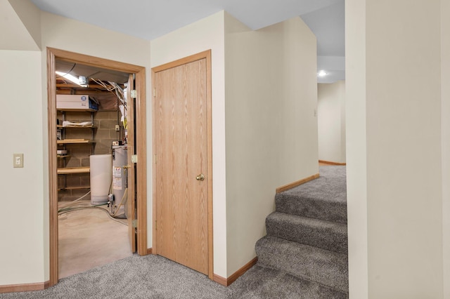 13842 Redwood St NW, Andover, MN 55304 - hallway featuring carpet flooring, gas water heater, baseboards, and stairs
