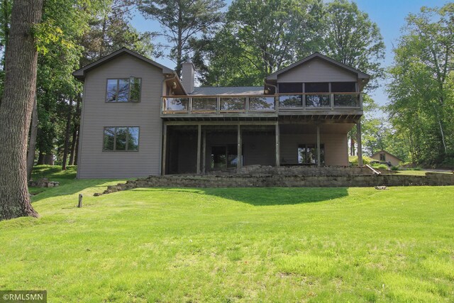 49063 203rd Pl, Mcgregor, MN 55760 - back of house with a chimney, a deck, a yard, and a sunroom