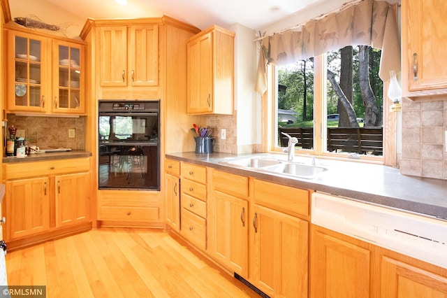 49063 203rd Pl, Mcgregor, MN 55760 - kitchen with a sink, decorative backsplash, light brown cabinetry, light wood-style flooring, and glass insert cabinets