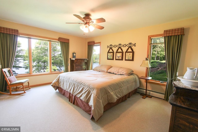 49063 203rd Pl, Mcgregor, MN 55760 - bedroom featuring baseboard heating, carpet floors, baseboards, and ceiling fan