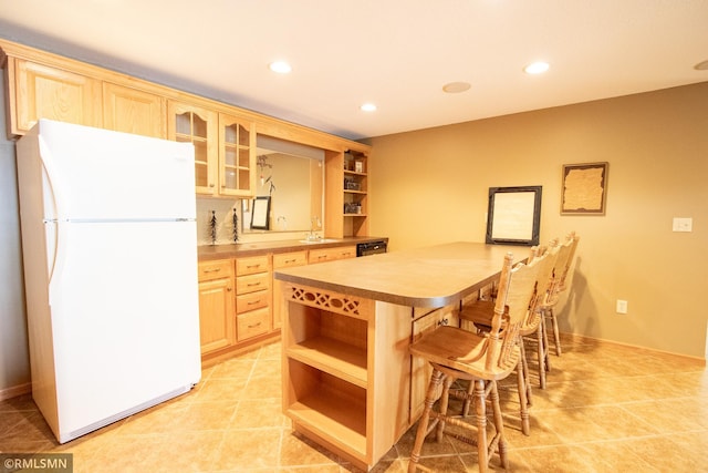 49063 203rd Pl, Mcgregor, MN 55760 - kitchen featuring freestanding refrigerator, open shelves, a kitchen bar, light brown cabinetry, and recessed lighting