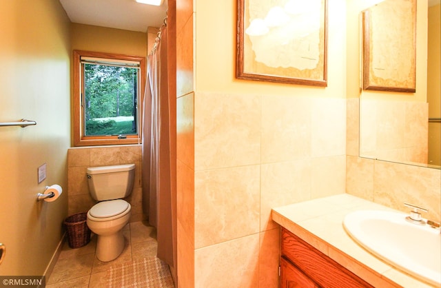 49063 203rd Pl, Mcgregor, MN 55760 - bathroom with tile walls, toilet, vanity, and tile patterned floors