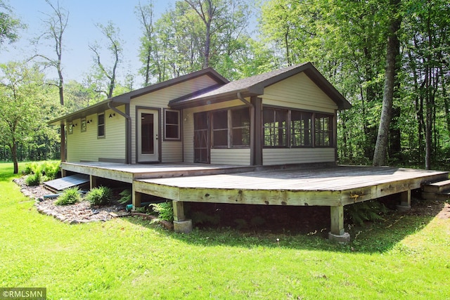 49063 203rd Pl, Mcgregor, MN 55760 - rear view of property with a wooden deck, a sunroom, and a lawn