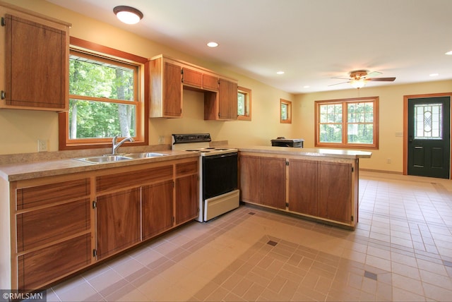 49063 203rd Pl, Mcgregor, MN 55760 - kitchen featuring white range with electric cooktop, a sink, a peninsula, light countertops, and recessed lighting