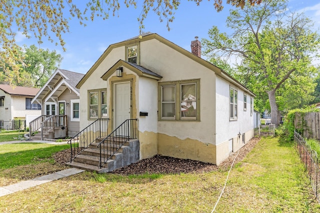 5420 Fremont Ave N, Brooklyn Center, MN 55430 - view of front of house featuring a chimney and stucco siding