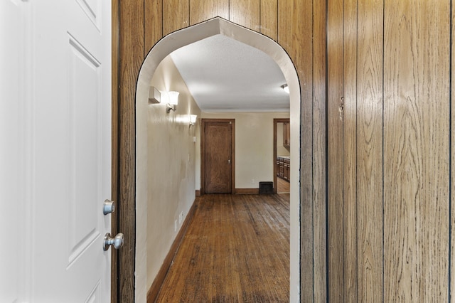 5420 Fremont Ave N, Brooklyn Center, MN 55430 - hallway featuring arched walkways, dark wood-style floors, and baseboards