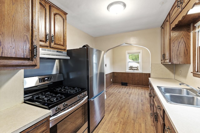 5420 Fremont Ave N, Brooklyn Center, MN 55430 - kitchen featuring appliances with stainless steel finishes, under cabinet range hood, a sink, light wood-style flooring, and light countertops