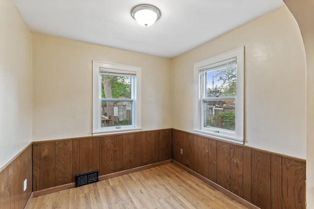 5420 Fremont Ave N, Brooklyn Center, MN 55430 - spare room with wainscoting, light wood-style flooring, and wooden walls