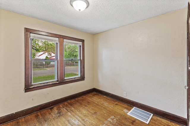 5420 Fremont Ave N, Brooklyn Center, MN 55430 - empty room featuring wood finished floors, baseboards, and a textured ceiling