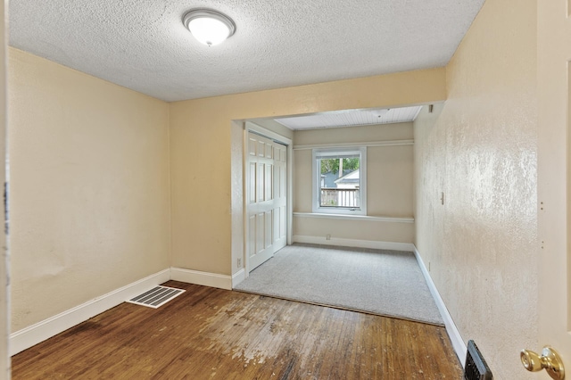 5420 Fremont Ave N, Brooklyn Center, MN 55430 - unfurnished bedroom featuring baseboards, wood finished floors, a textured ceiling, and a closet