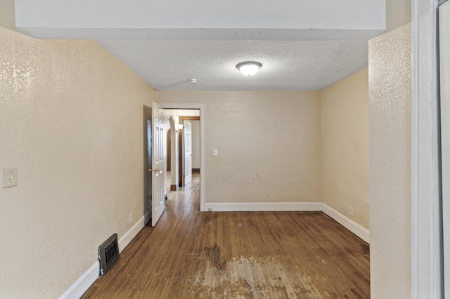 5420 Fremont Ave N, Brooklyn Center, MN 55430 - spare room with wood finished floors, baseboards, and a textured ceiling