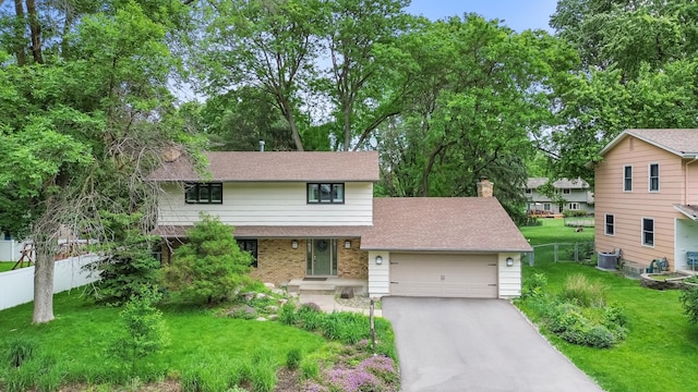 6521 Gleason Rd, Edina, MN 55439 - tri-level home with a garage, asphalt driveway, brick siding, a chimney, and roof with shingles