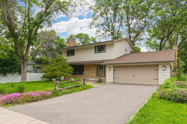 6521 Gleason Rd, Edina, MN 55439 - traditional-style house with a chimney, a garage, asphalt driveway, and brick siding