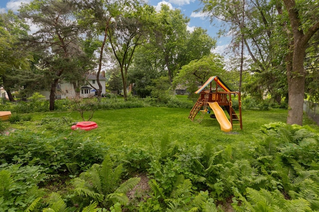 6521 Gleason Rd, Edina, MN 55439 - view of grassy yard with a playground and view of wooded area