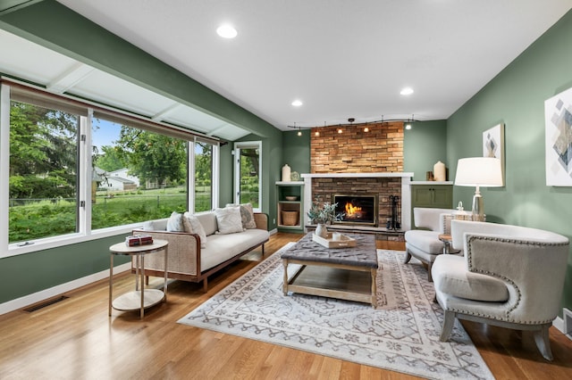 6521 Gleason Rd, Edina, MN 55439 - living area featuring wood finished floors, a fireplace, rail lighting, and recessed lighting