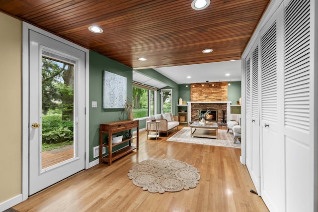 6521 Gleason Rd, Edina, MN 55439 - living area featuring wooden ceiling, light wood finished floors, healthy amount of natural light, a brick fireplace, and recessed lighting