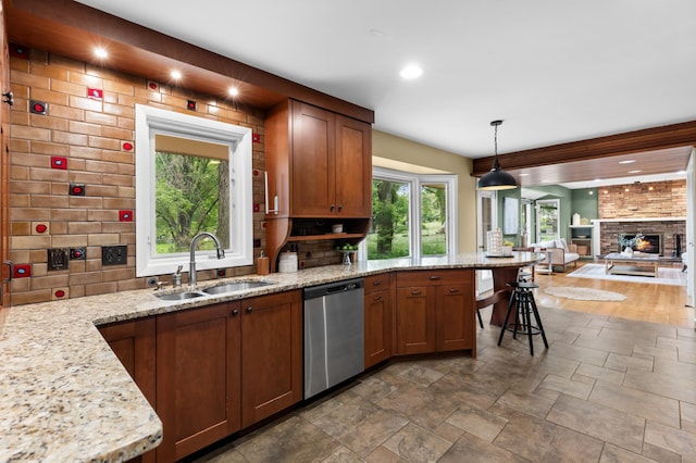 6521 Gleason Rd, Edina, MN 55439 - kitchen featuring stainless steel dishwasher, stone tile floors, open floor plan, a peninsula, and light stone counters