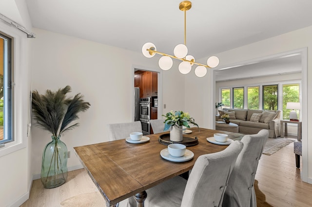 6521 Gleason Rd, Edina, MN 55439 - dining room featuring light wood finished floors and a chandelier
